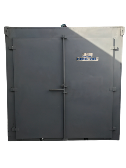 back view of woman wearing a backpack and beanie waiting to cross the road on a busy street at night in New York City, USA